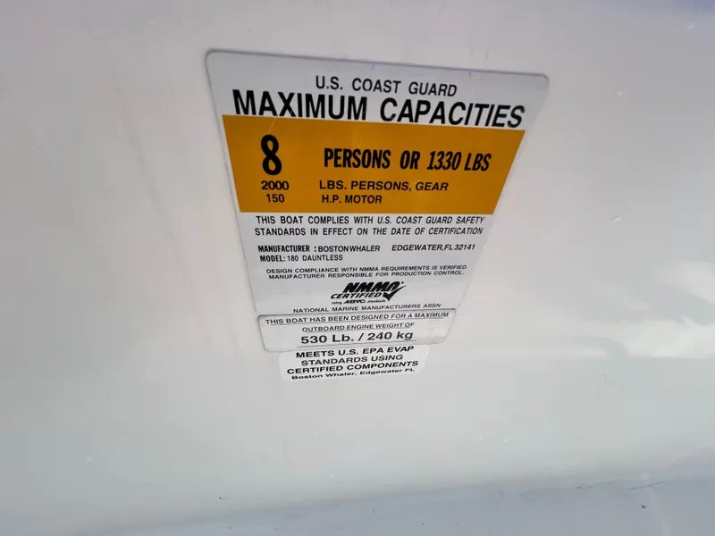 Slide: The Image of U.S. Coast Guard capacity label on 2011 Boston Whaler DAUNTLESS 180/CC boat. - 15