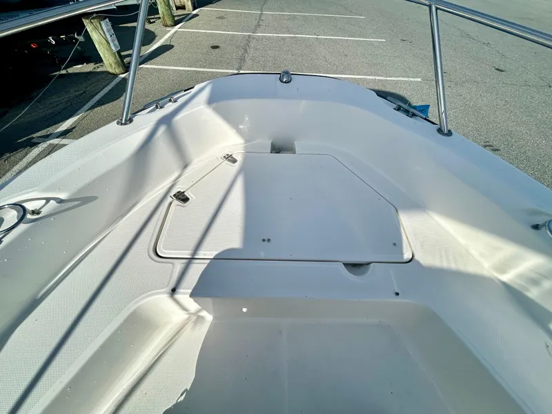 Slide: The Image of 2011 Boston Whaler DAUNTLESS 180/CC boat interior, showing spacious deck and storage compartment. - 8