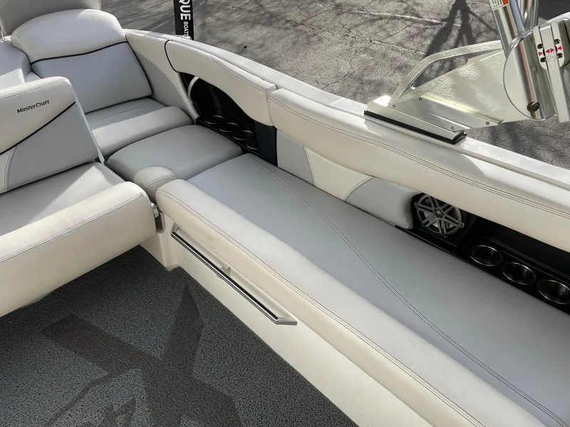 Slide: The Image of 2016 MasterCraft X46 boat interior with white leather seating and speaker system. - 10