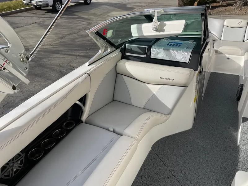 Slide: The Image of 2016 MasterCraft X46 boat interior with white leather seating and modern dashboard. - 11