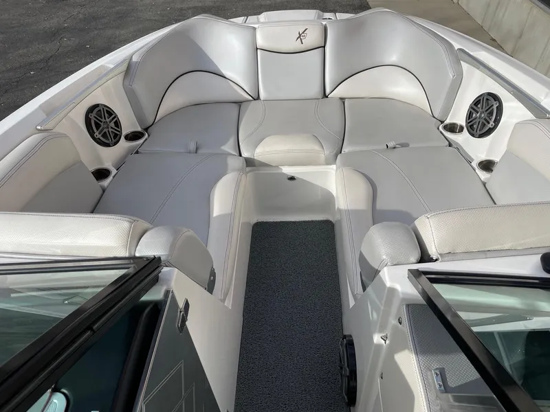 Slide: The Image of 2016 MasterCraft X46 boat interior with gray seating and speakers. - 12