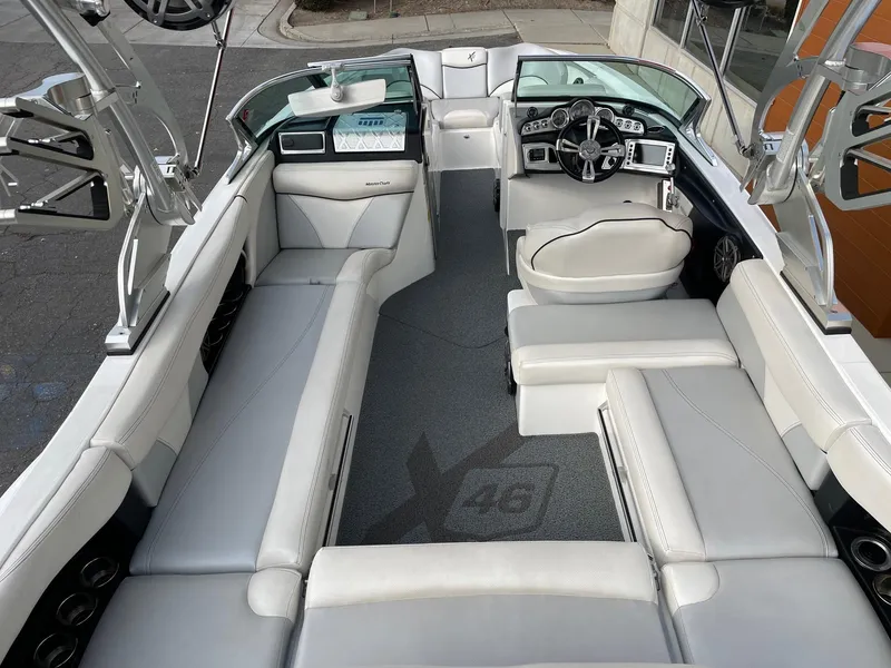 Slide: The Image of 2016 MasterCraft X46 boat interior with white seating and modern dashboard. - 6