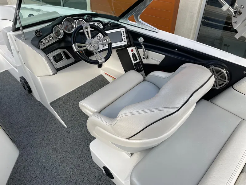 Slide: The Image of 2016 MasterCraft X46 boat interior with sleek dashboard and comfortable seating. - 7