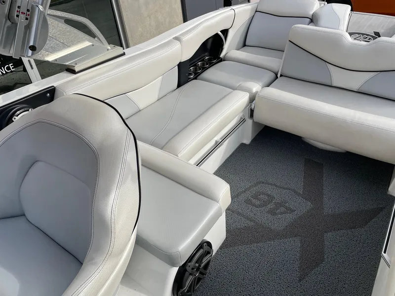 Slide: The Image of 2016 MasterCraft X46 boat interior with luxurious white seating and carpeted flooring. - 8