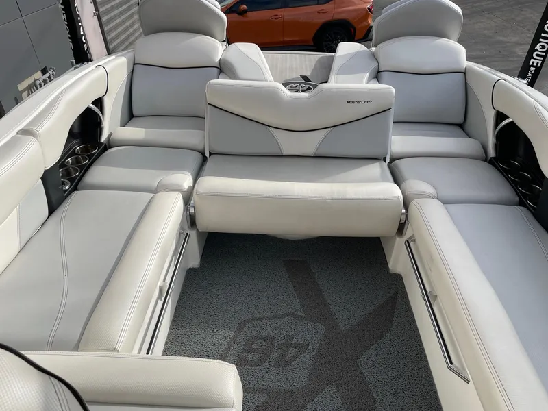 Slide: The Image of 2016 MasterCraft X46 boat interior with white leather seating and carpeted floor. - 9