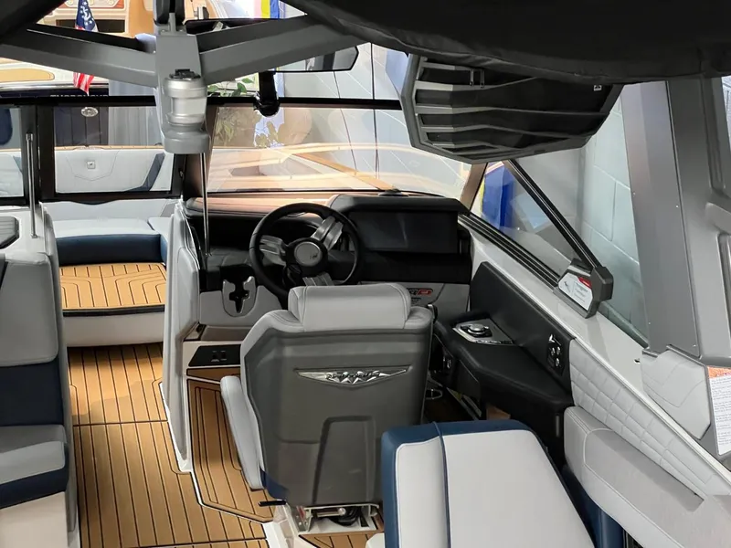 Slide: The Image of Interior of 2023 Nautique Super Air Nautique G25 boat with modern helm and seating. - 11