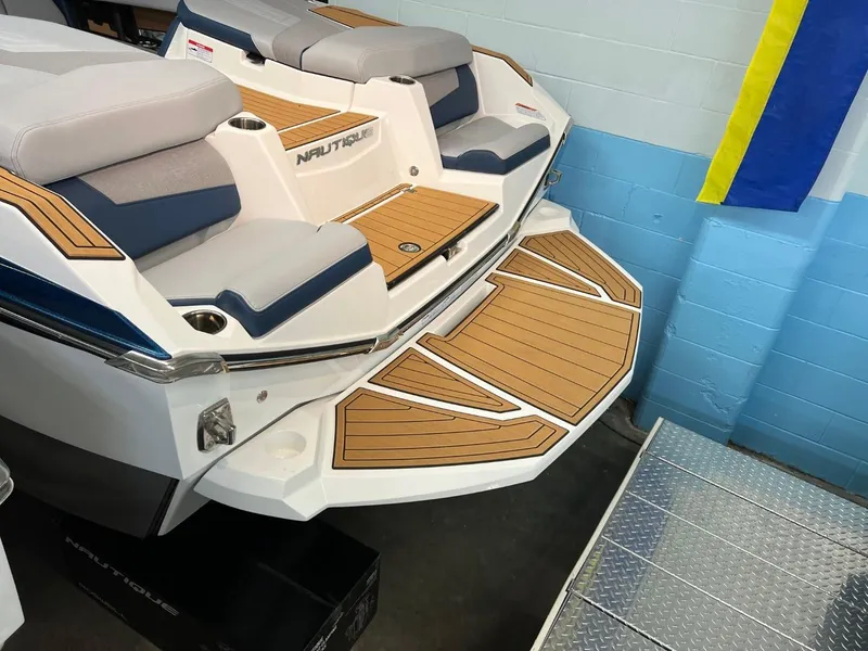 Slide: The Image of 2023 Nautique Super Air Nautique G25 boat with teak deck and cushioned seating. - 4