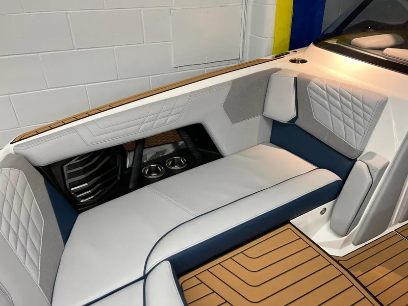 Slide: The Image of 2023 Nautique Super Air Nautique G25 interior with luxury seating and cup holders. - 7