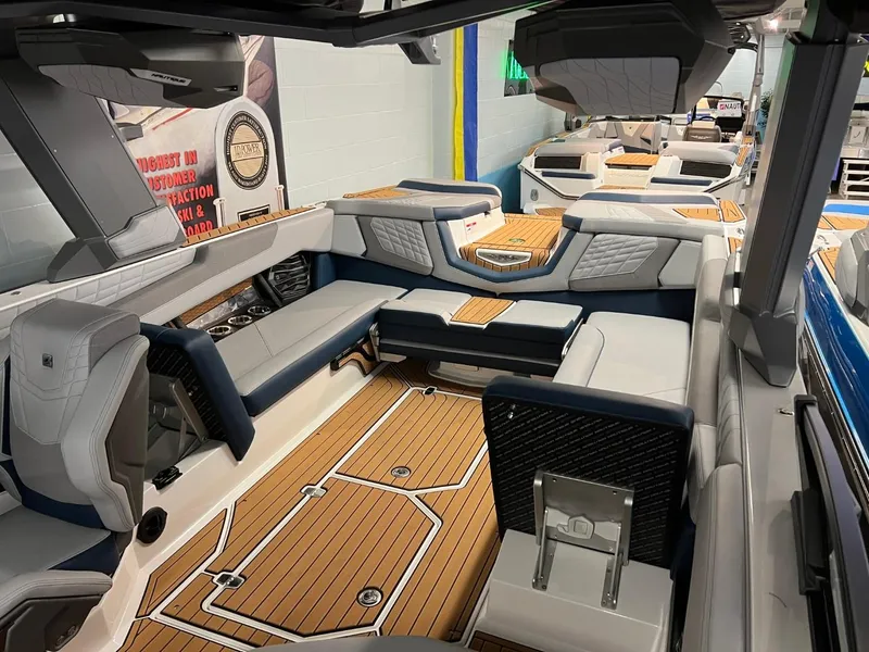 Slide: The Image of 2023 Nautique Super Air Nautique G25 interior with luxurious seating and teak flooring. - 8