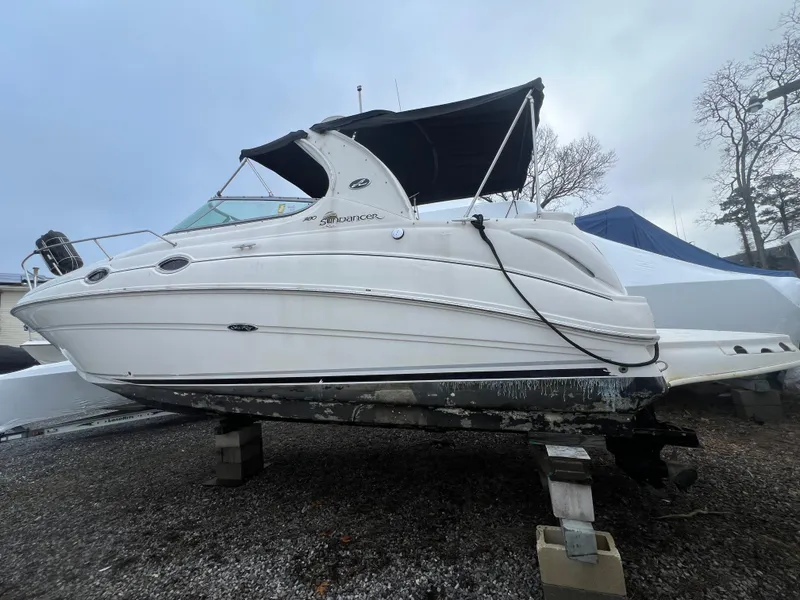 The Image of 2008 Sea Ray 280 Sundancer boat on dry dock, white hull, black canopy. - 0