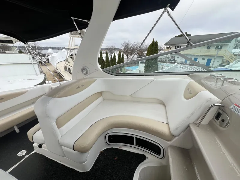 Slide: The Image of 2008 Sea Ray 280 Sundancer boat interior with white and beige seating. - 10