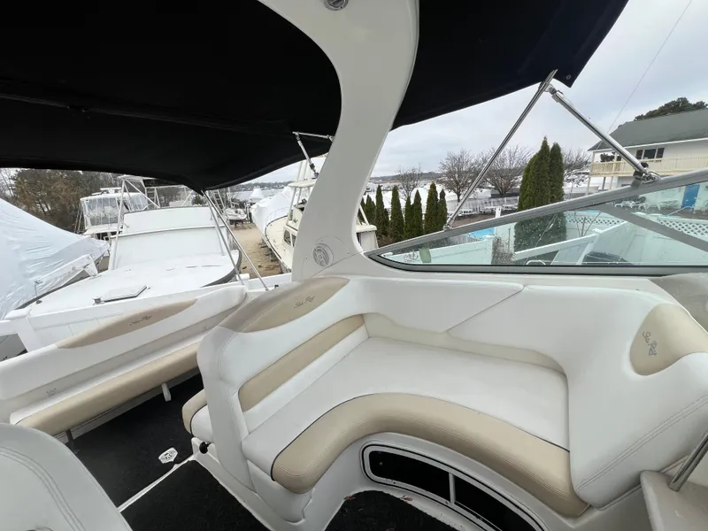 Slide: The Image of 2008 Sea Ray 280 Sundancer interior with beige seating and black canopy. - 11