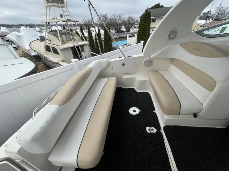 Slide: The Image of 2008 Sea Ray 280 Sundancer boat interior with beige and white seating. - 14