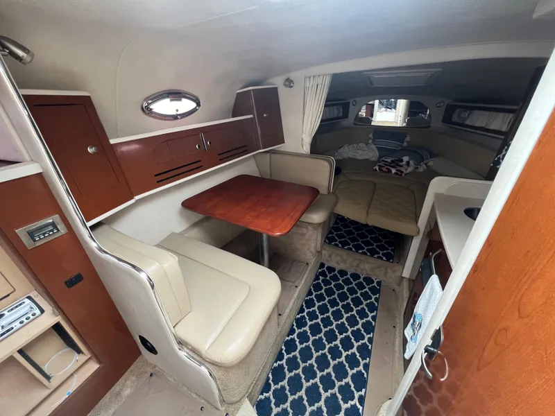 Slide: The Image of Interior of 2008 Sea Ray 280 Sundancer with seating, table, and cozy cabin layout. - 19
