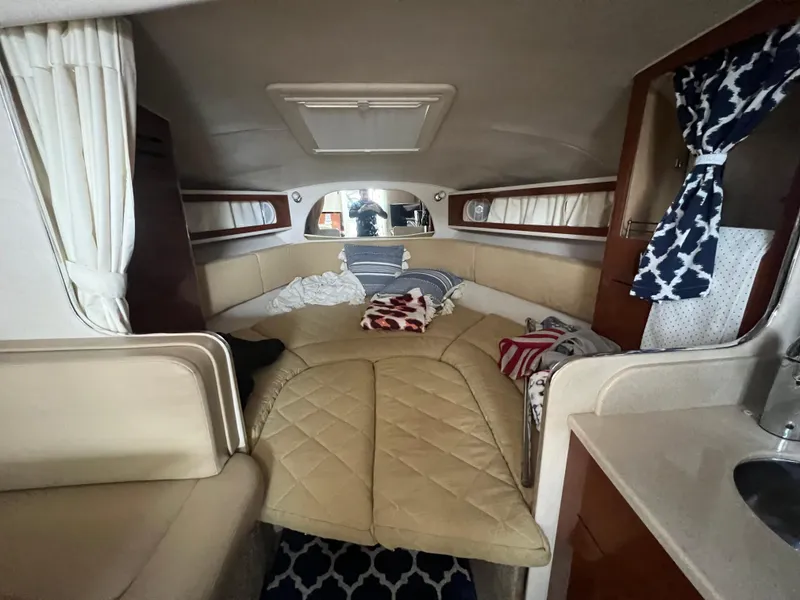 Slide: The Image of Interior of 2008 Sea Ray 280 Sundancer boat with cozy cabin and bedding. - 21