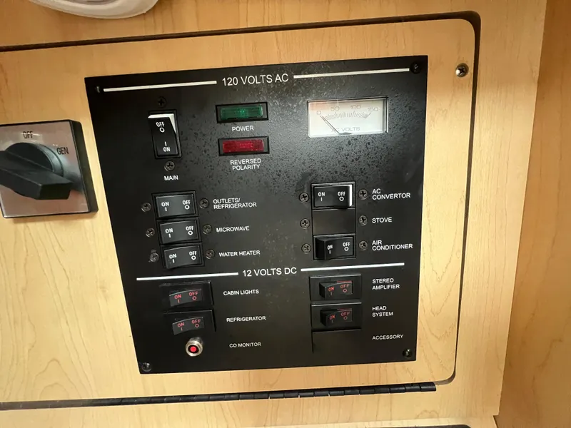 Slide: The Image of Control panel of a 2008 Sea Ray 280 Sundancer boat, featuring AC and DC switches. - 24
