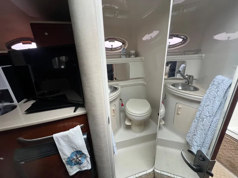 Slide: The Image of Interior of 2008 Sea Ray 280 Sundancer showing bathroom with sink and toilet. - 26