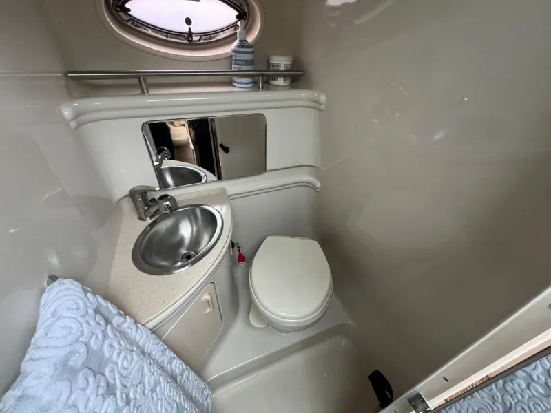 Slide: The Image of 2008 Sea Ray 280 Sundancer bathroom with sink, toilet, and mirror. - 27