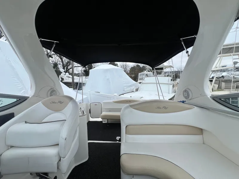 Slide: The Image of Interior view of 2008 Sea Ray 280 Sundancer boat with beige seating and black canopy. - 30