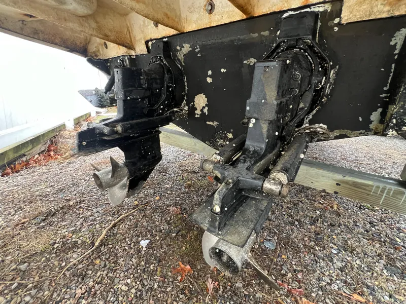 Slide: The Image of 2008 Sea Ray 280 Sundancer boat outdrive and propellers on gravel surface. - 32