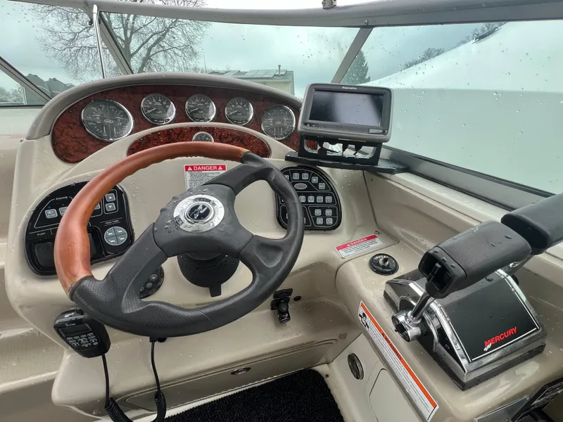 Slide: The Image of 2008 Sea Ray 280 Sundancer helm with steering wheel and control panel. - 4