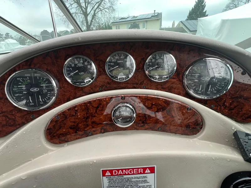 Slide: The Image of Dashboard of 2008 Sea Ray 280 Sundancer with wood finish and gauges. - 9
