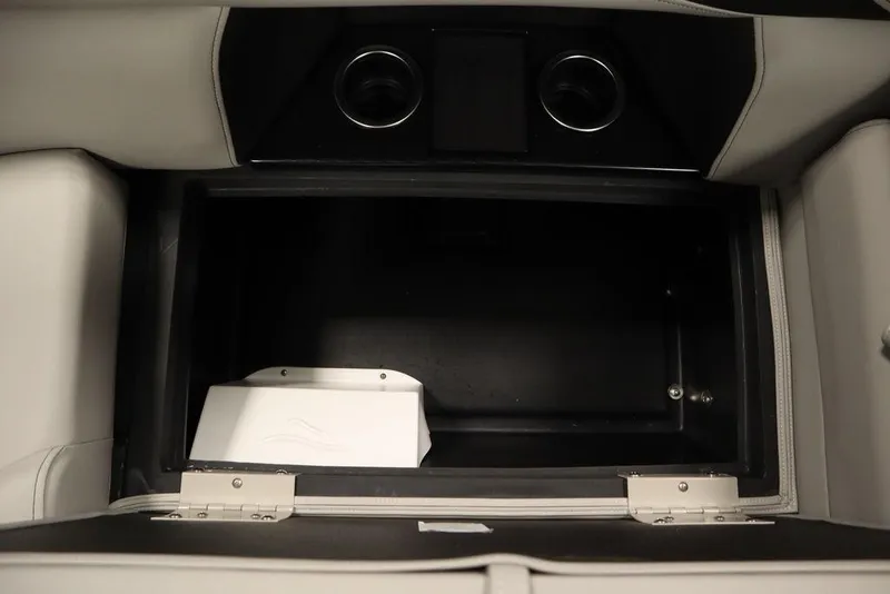 Slide: The Image of Storage compartment in 2025 Trifecta 24RF LE 2.75 boat, featuring cup holders and sleek design. - 33