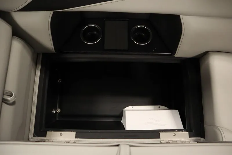 Slide: The Image of Interior storage compartment of 2025 Trifecta 24RF LE 2.75 with cup holders. - 34