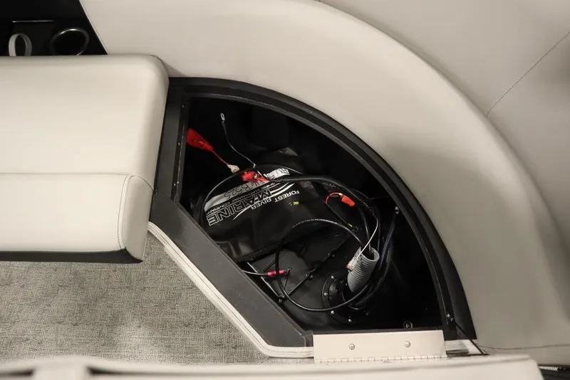 Slide: The Image of Battery compartment of 2025 Trifecta 24RF LE 2.75 pontoon boat, featuring wiring and storage. - 37