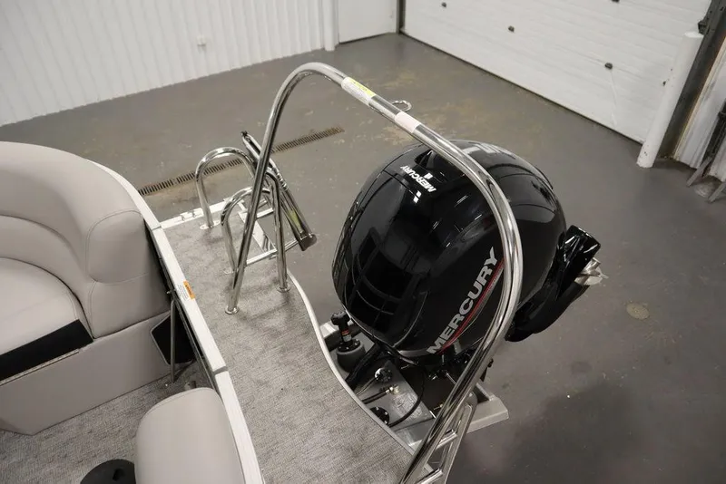 Slide: The Image of 2025 Trifecta 24RF LE 2.75 boat with Mercury outboard motor in a garage. - 42