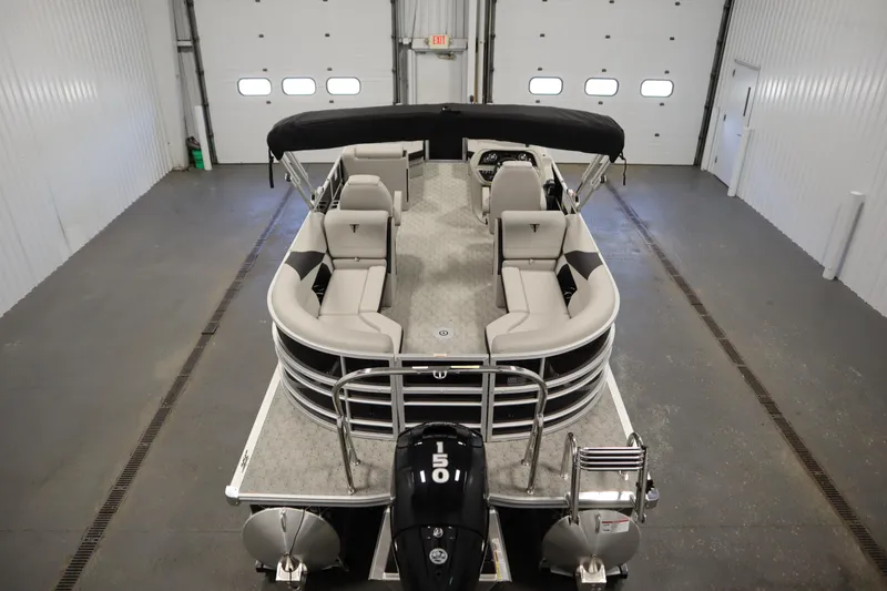 Slide: The Image of 2025 Trifecta 24RF LE 2.75 pontoon boat in a garage setting. - 8