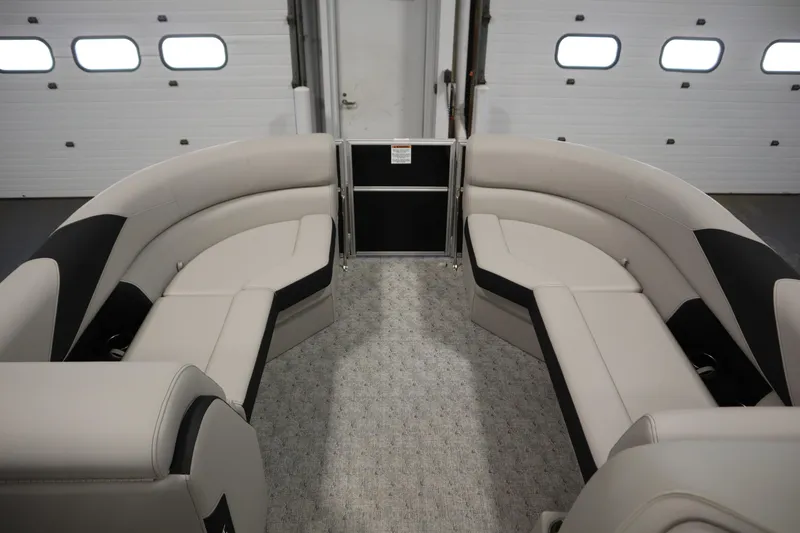 Slide: The Image of 2025 Trifecta 24RF LE 2.75 pontoon boat with Mercury outboard motor in a garage. - 9