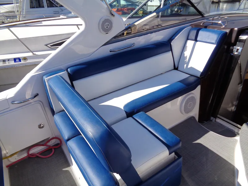 Slide: The Image of 2014 Regal 3060 Window Express boat interior with blue and white seating. - 10