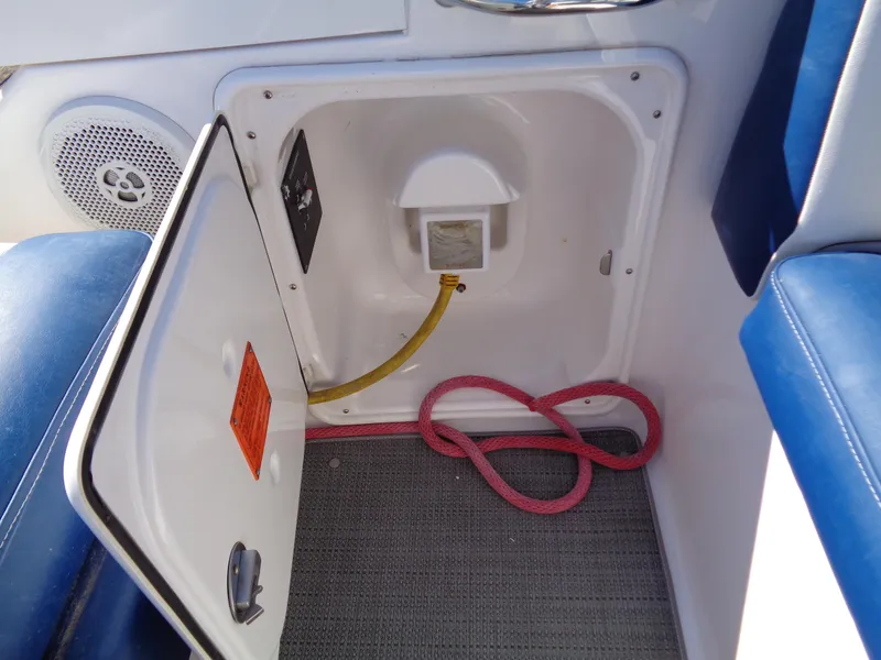 Slide: The Image of Open storage compartment on 2014 Regal 3060 Window Express boat interior. - 11