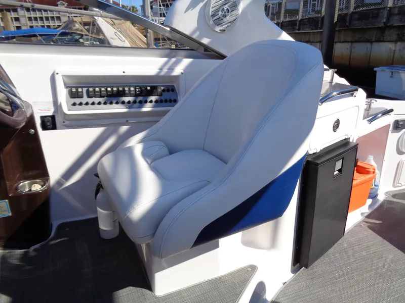 Slide: The Image of 2014 Regal 3060 Window Express boat cockpit with plush captain's chair. - 14