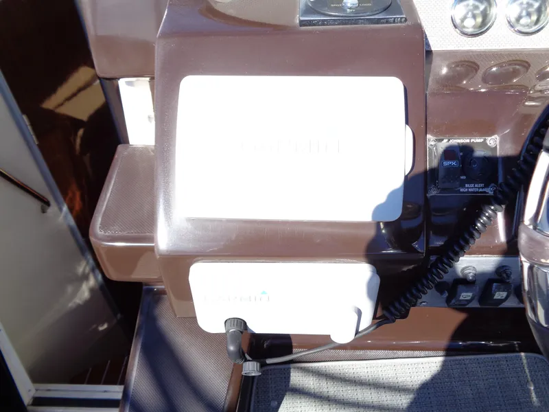 Slide: The Image of 2014 Regal 3060 Window Express boat dashboard with controls and navigation equipment. - 17