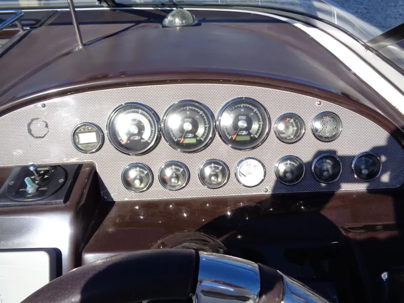 Slide: The Image of Dashboard of a 2014 Regal 3060 Window Express boat with multiple gauges and controls. - 18