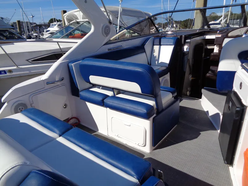 Slide: The Image of 2014 Regal 3060 Window Express boat interior with blue and white seating. - 19