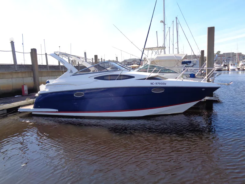 Slide: The Image of 2014 Regal 3060 Window Express boat docked in marina. - 2