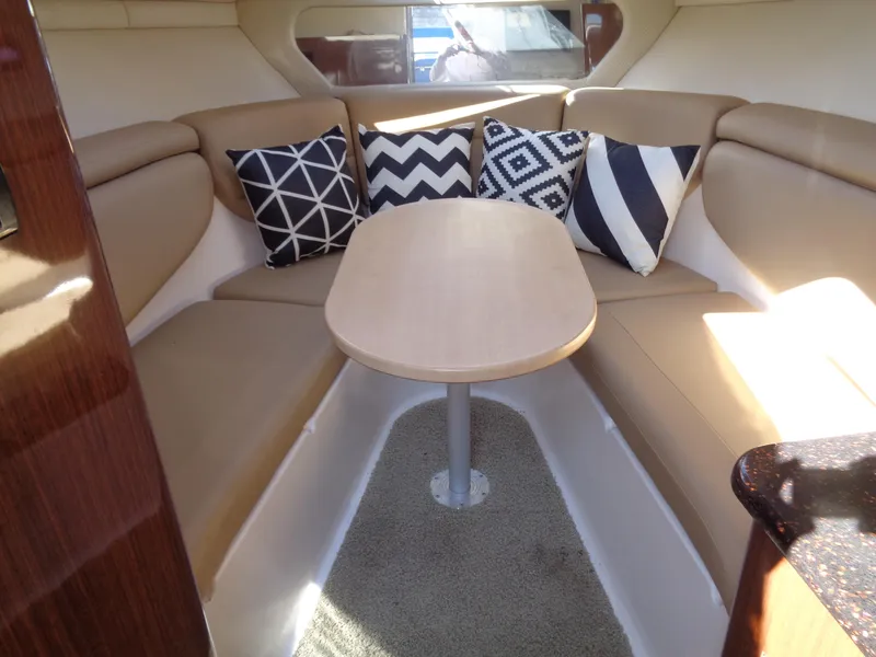 Slide: The Image of 2014 Regal 3060 Window Express cabin with cozy seating and decorative pillows. - 22