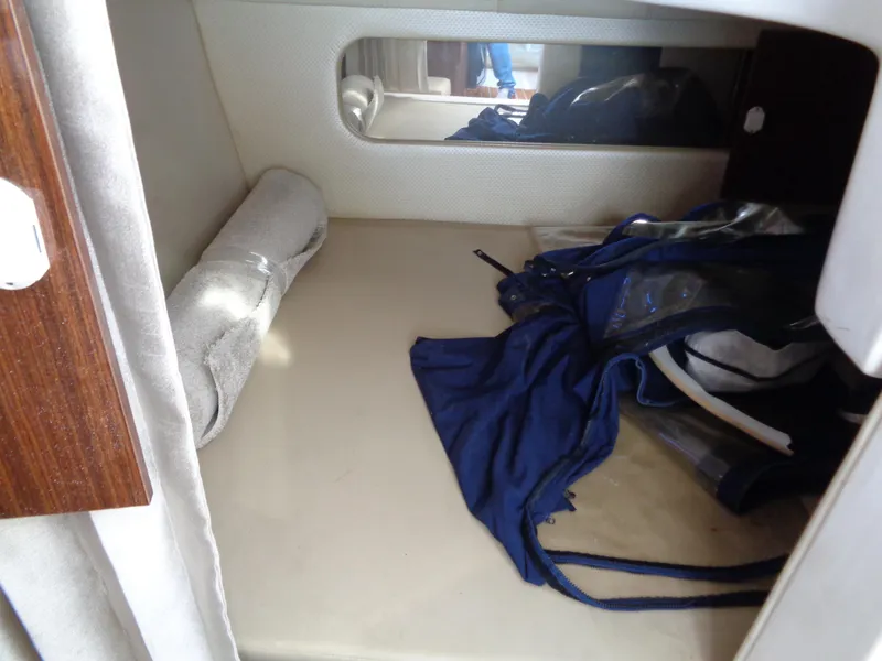 Slide: The Image of 2014 Regal 3060 Window Express cabin interior with bed and clothing. - 23