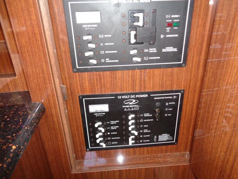 Slide: The Image of Control panel of a 2014 Regal 3060 Window Express boat, featuring AC and DC power switches. - 25