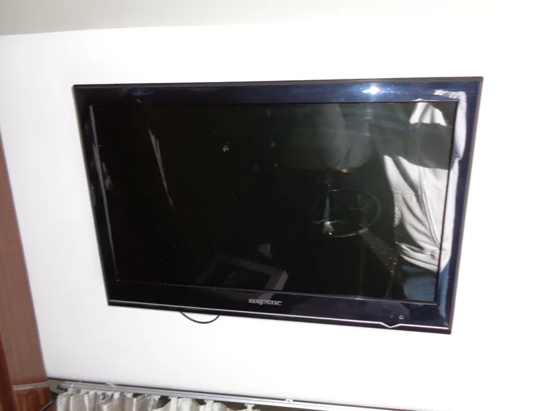 Slide: The Image of Flat-screen TV mounted on a 2014 Regal 3060 Window Express boat interior. - 27