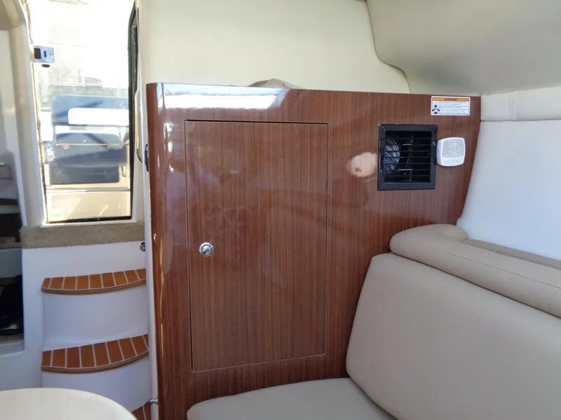 Slide: The Image of 2014 Regal 3060 Window Express interior with wood paneling and beige seating. - 29