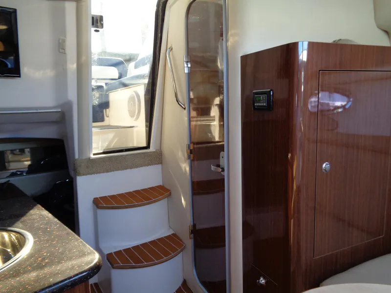 Slide: The Image of Interior of 2014 Regal 3060 Window Express yacht with wooden steps and modern design. - 31