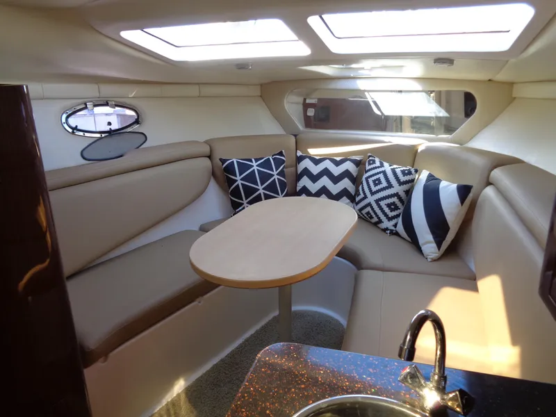 Slide: The Image of 2014 Regal 3060 Window Express cabin with seating, table, and decorative pillows. - 33