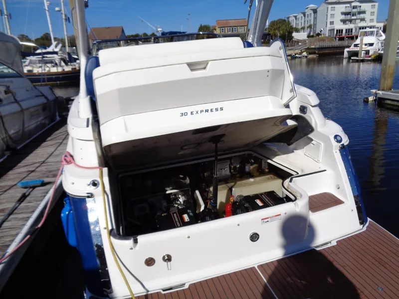 Slide: The Image of 2014 Regal 3060 Window Express boat engine compartment open at dock. - 35