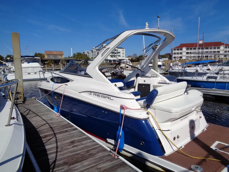 Slide: The Image of 2014 Regal 3060 Window Express boat docked at marina under clear blue sky. - 4