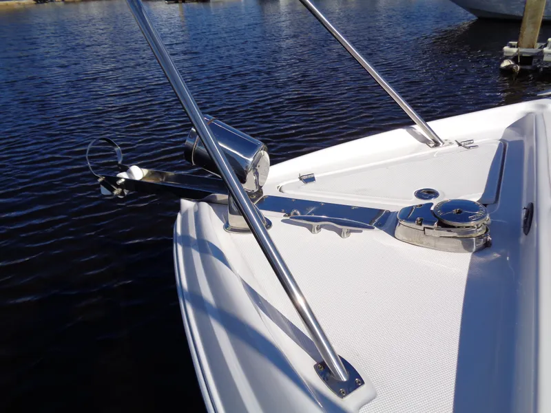 Slide: The Image of 2014 Regal 3060 Window Express boat bow with anchor on calm water. - 5