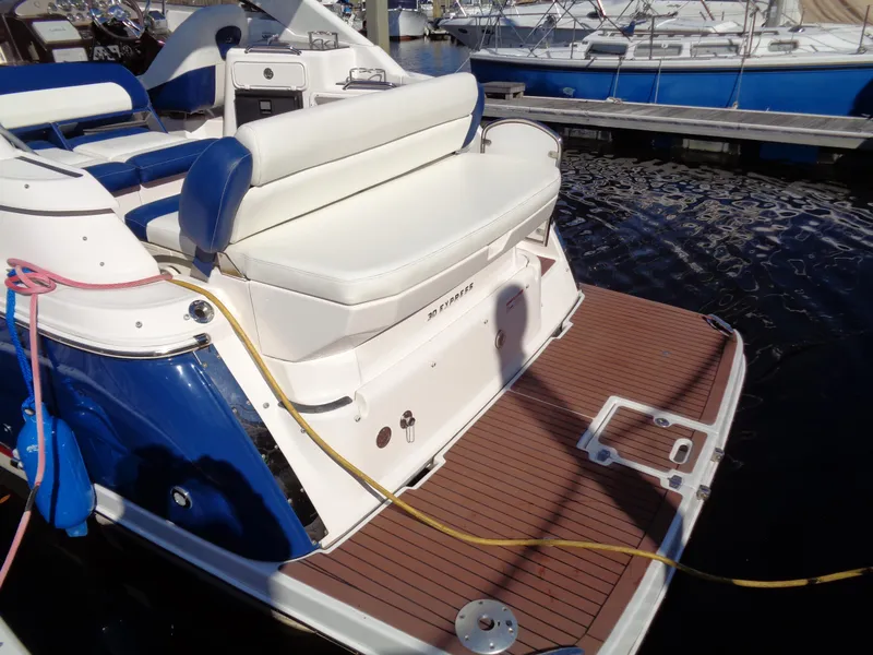 Slide: The Image of 2014 Regal 3060 Window Express boat with spacious deck and seating at a marina. - 7